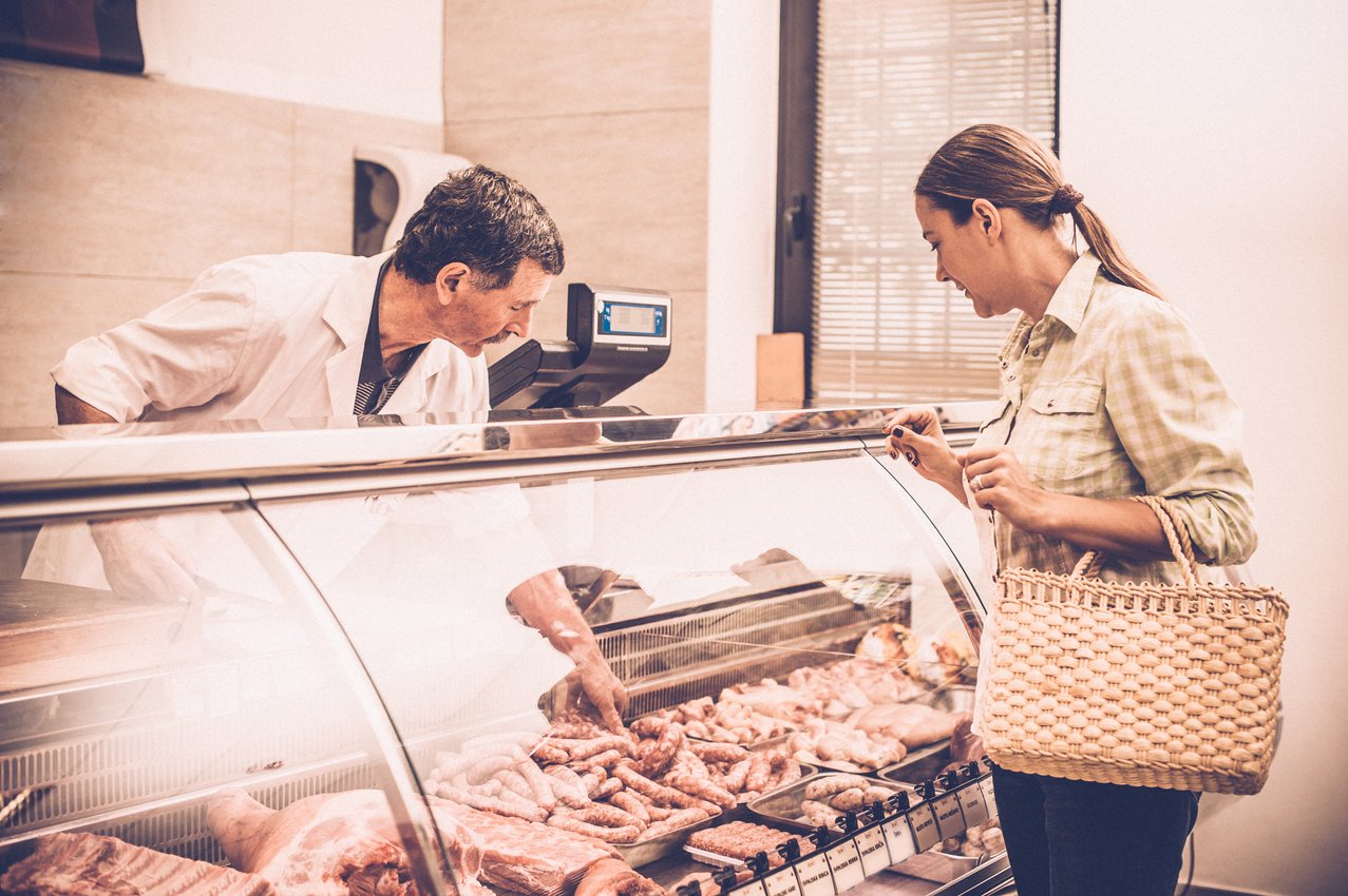 woman buying meat at the butcher shop